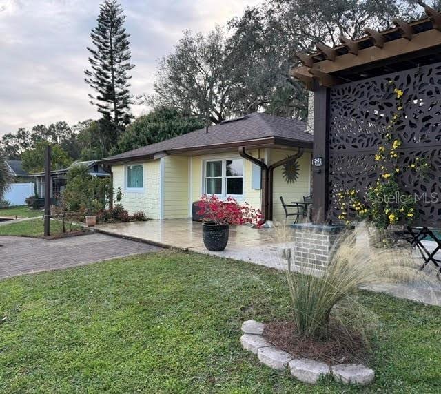 exterior space featuring a lawn and a patio area