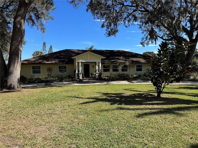 ranch-style home featuring a front yard