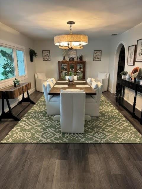 dining area featuring an inviting chandelier and dark hardwood / wood-style floors