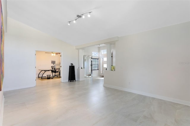 empty room with lofted ceiling and ceiling fan