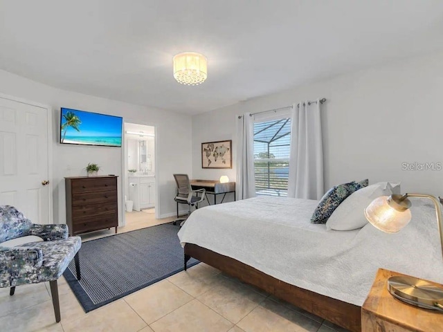 bedroom featuring light tile patterned flooring and ensuite bath