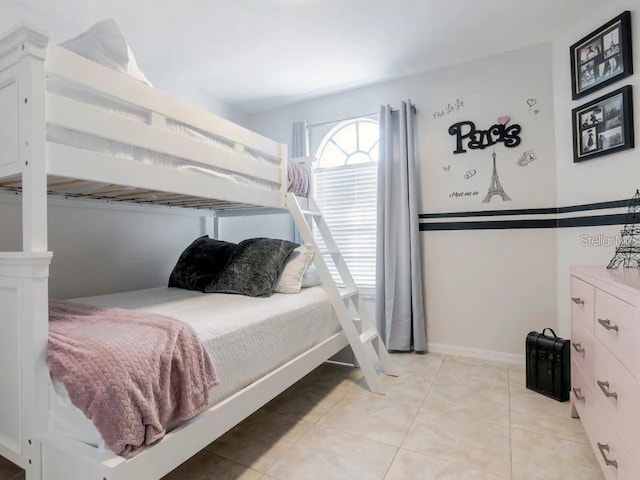 bedroom with light tile patterned floors