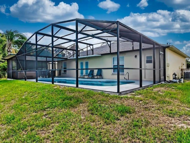 back of house featuring a lanai, a lawn, central air condition unit, and a patio area