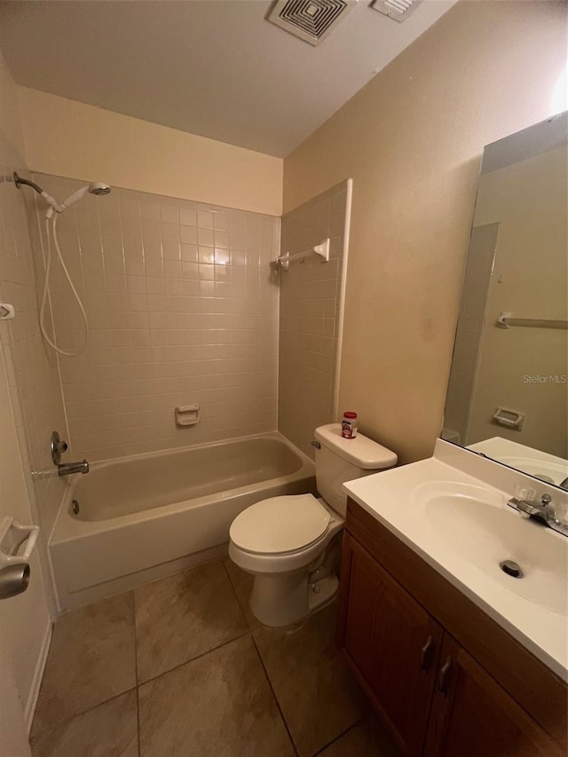 full bathroom with vanity, tile patterned flooring, tiled shower / bath combo, and toilet