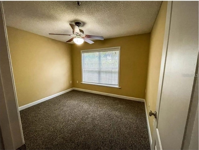 carpeted spare room with a textured ceiling and ceiling fan