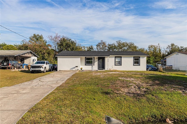 ranch-style home with a carport and a front yard