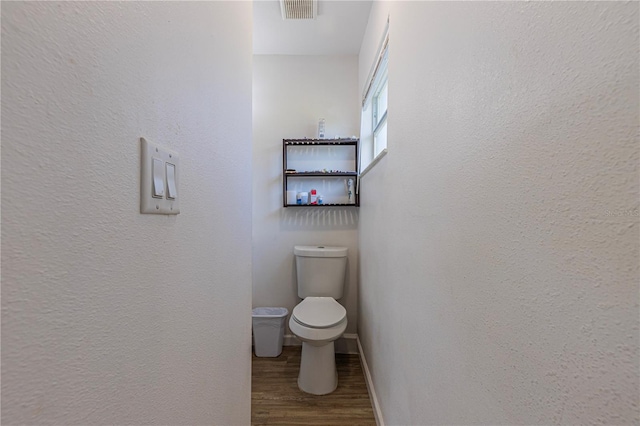 bathroom featuring hardwood / wood-style floors and toilet