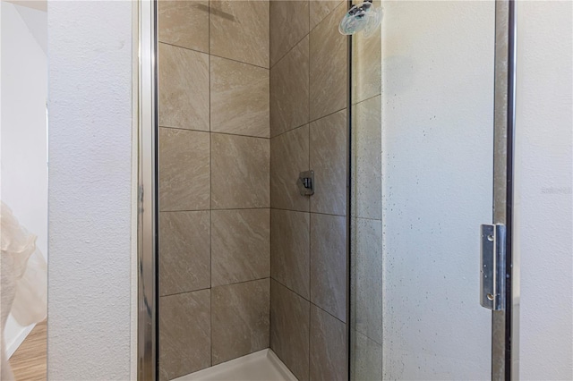 bathroom with a shower with shower door