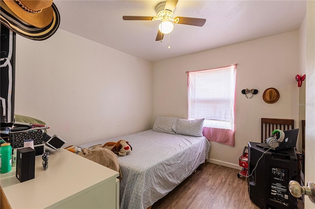 bedroom featuring ceiling fan and dark hardwood / wood-style floors