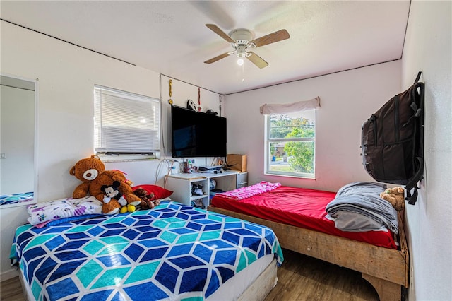 bedroom featuring a textured ceiling, wood-type flooring, and ceiling fan