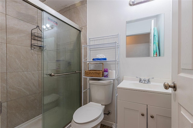 bathroom with vanity, an enclosed shower, and toilet