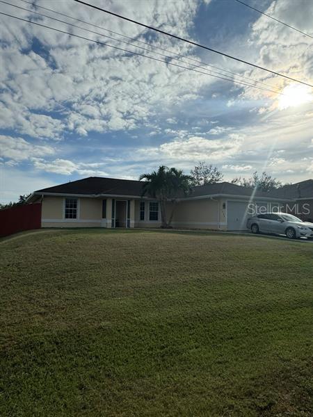 ranch-style home with a front yard