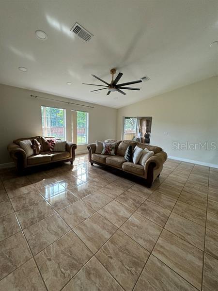 living room featuring lofted ceiling and ceiling fan