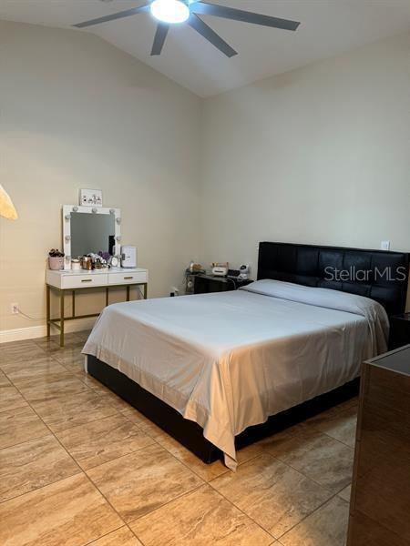 bedroom featuring vaulted ceiling and ceiling fan