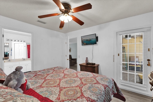 bedroom with sink, ceiling fan, connected bathroom, light hardwood / wood-style floors, and access to outside