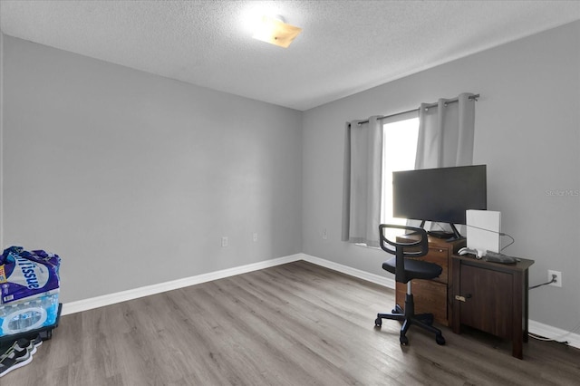 office with hardwood / wood-style flooring and a textured ceiling