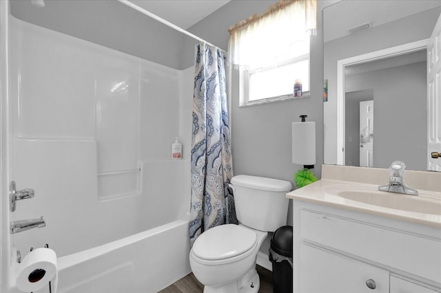 full bathroom featuring shower / tub combo with curtain, vanity, and toilet