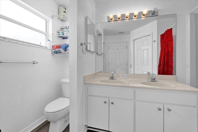 bathroom with vanity, a shower with shower curtain, and toilet