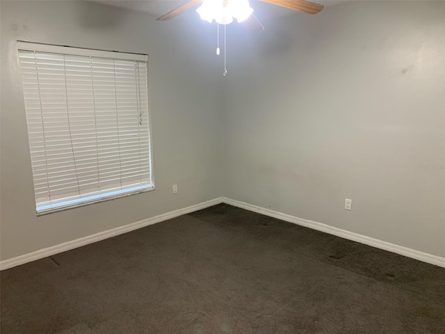 carpeted spare room with ceiling fan