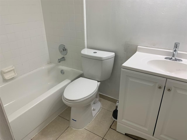 full bathroom with tile patterned flooring, vanity, tiled shower / bath combo, and toilet