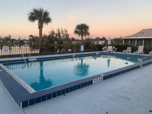 view of pool at dusk