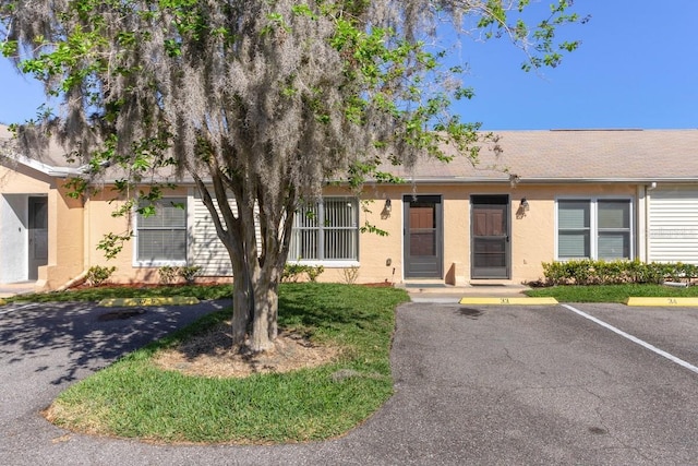 ranch-style home with stucco siding and uncovered parking