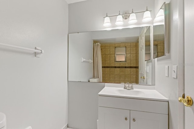 bathroom featuring curtained shower, toilet, and vanity