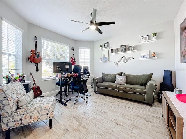 office space featuring ceiling fan, a textured ceiling, and light hardwood / wood-style flooring