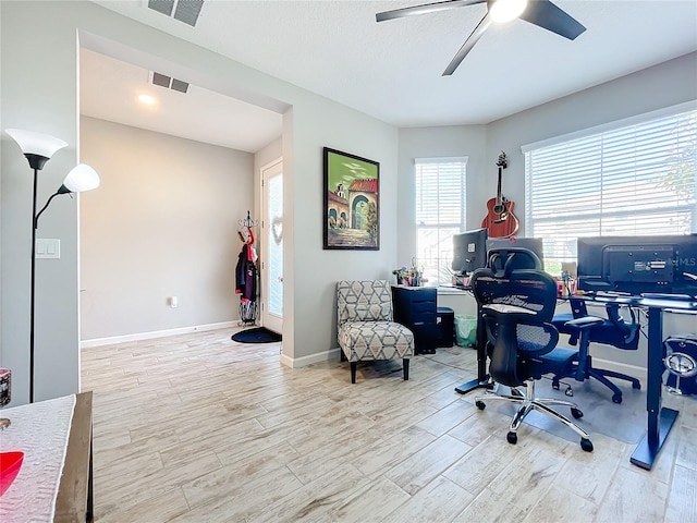 home office featuring a textured ceiling, ceiling fan, and light wood-type flooring