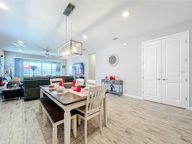 dining area with ceiling fan and light hardwood / wood-style floors