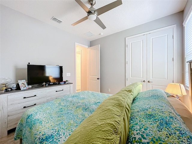 bedroom with ceiling fan and a closet