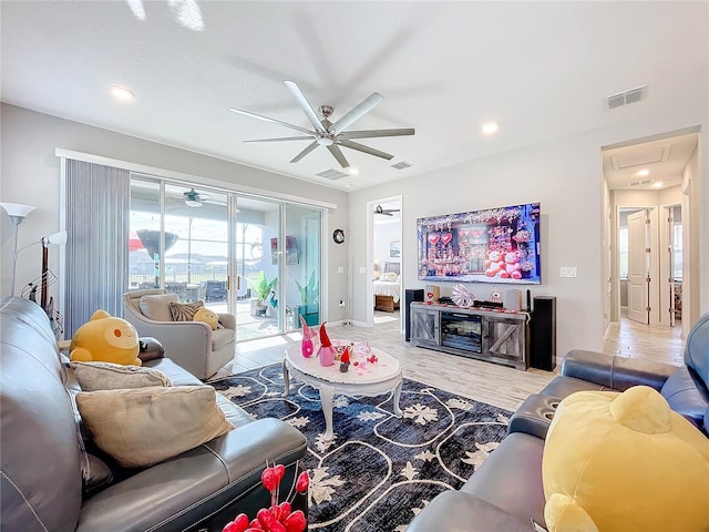 living room with hardwood / wood-style floors and ceiling fan