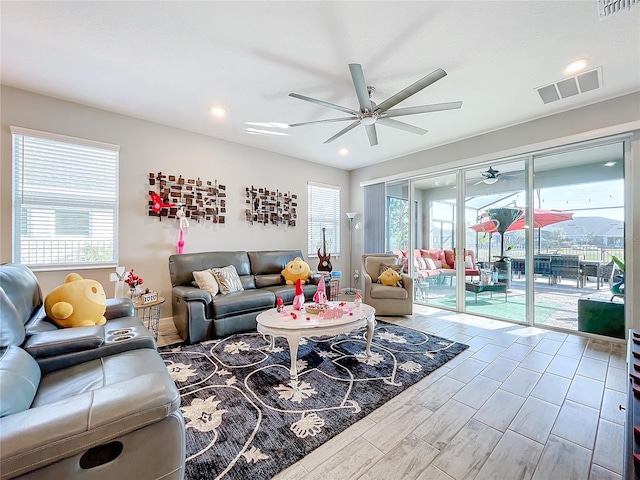 living room featuring ceiling fan and hardwood / wood-style floors