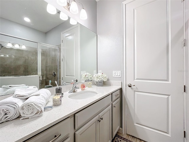 bathroom featuring an enclosed shower and vanity