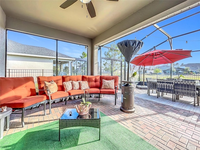 exterior space featuring an outdoor hangout area, ceiling fan, and glass enclosure