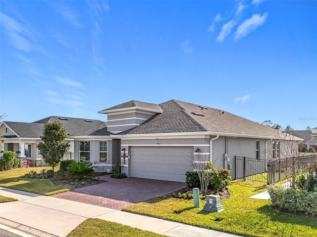 view of front of property featuring a garage and a front lawn