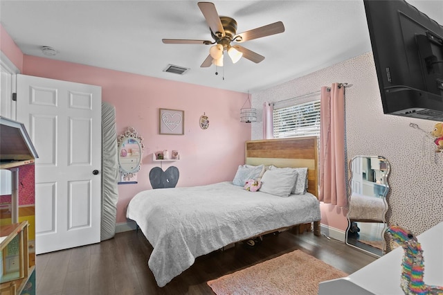 bedroom with dark hardwood / wood-style floors and ceiling fan