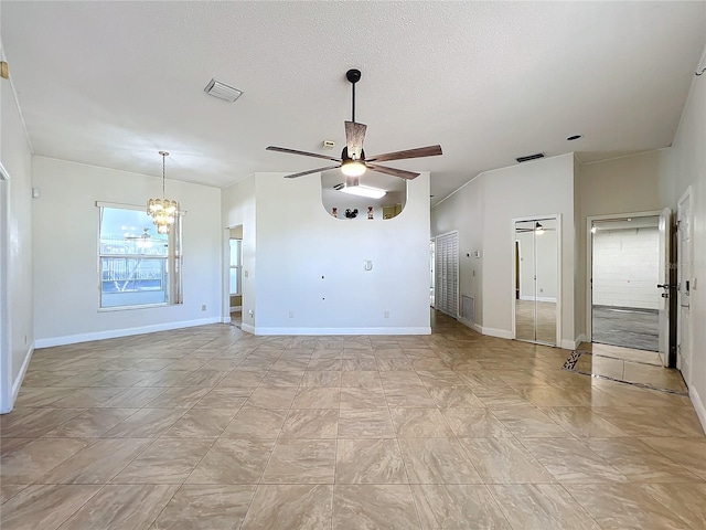 unfurnished living room featuring ceiling fan with notable chandelier and a textured ceiling