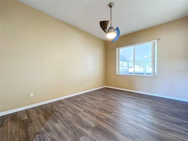 empty room with dark hardwood / wood-style flooring