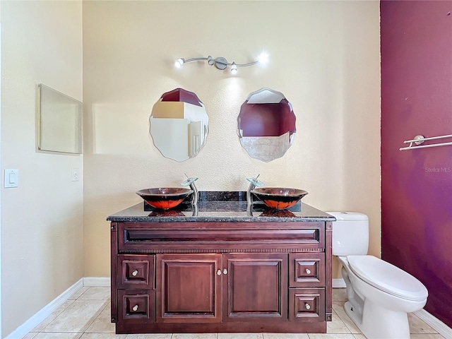 bathroom featuring tile patterned floors, toilet, and vanity