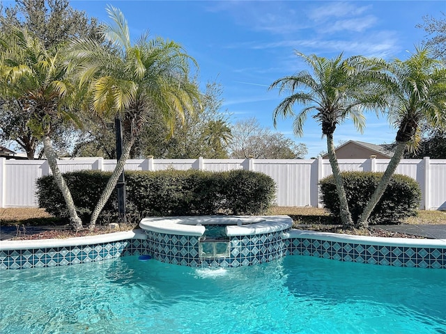 view of swimming pool featuring an in ground hot tub