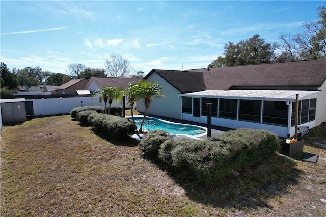 view of pool featuring a sunroom and a yard