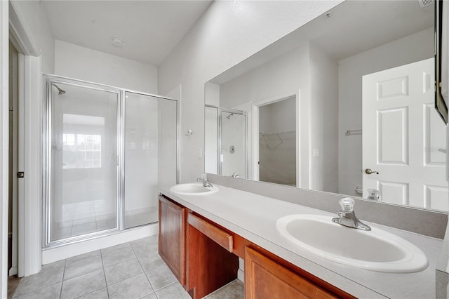 bathroom with tile patterned flooring, vanity, and a shower with shower door