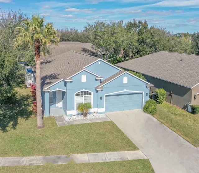 single story home featuring a garage and a front lawn