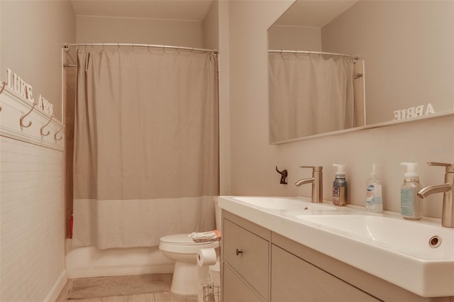 full bathroom with shower / tub combo with curtain, vanity, toilet, and tile patterned flooring