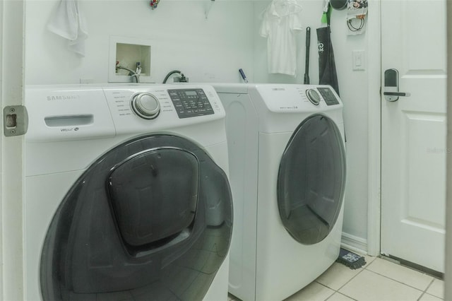 washroom featuring washer and dryer and light tile patterned floors