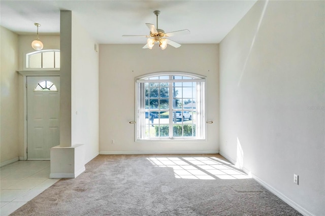 carpeted foyer featuring ceiling fan