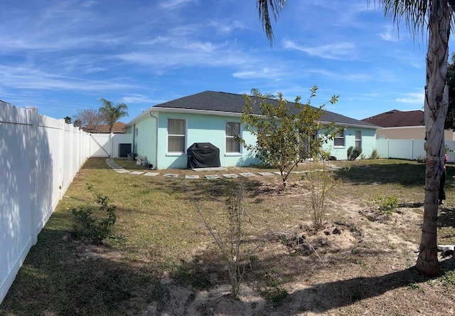 rear view of property with a lawn