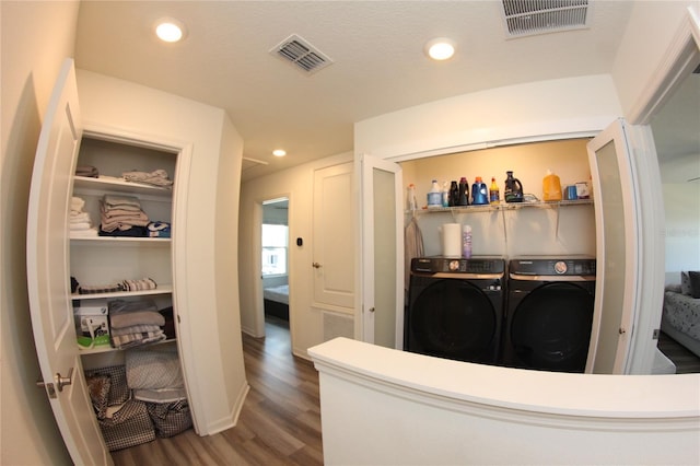 interior space with dark hardwood / wood-style flooring and washer and clothes dryer