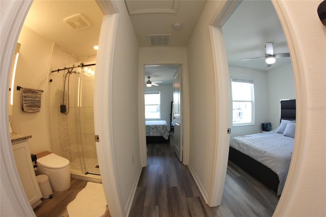 interior space with hardwood / wood-style flooring, a healthy amount of sunlight, and walk in shower